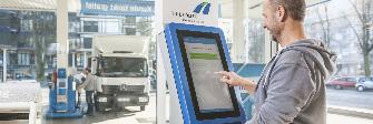 
A truck driver logging on at a toll terminal