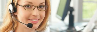 
A customer service staff member wearing a headset and talking on the phone