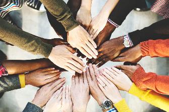 
Hand huddle with different skin tones.