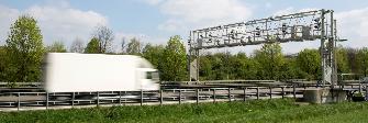 
A truck drives toward an enforcement gantry