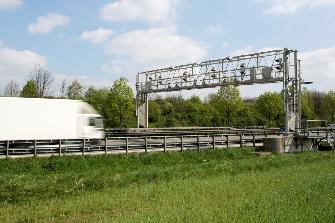 
A truck drives toward an enforcement gantry