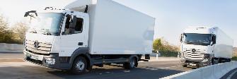 
Two trucks subject to toll driving behind one another on a motorway