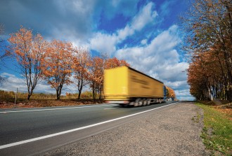 
Ein Lkw fährt im Herbst über eine Bundesstraße