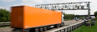 
A truck passes an enforcement gantry on the motorway