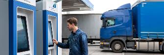 
A truck driver uses a toll terminal at a petrol station.