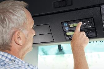 
A driver operating the On-Board Unit in a truck